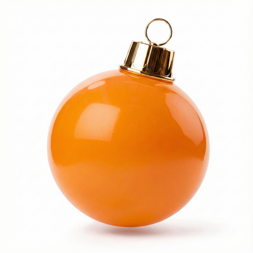 Orange Christmas ornament with gold cap on a white background
