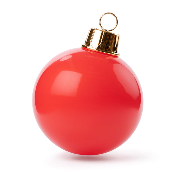 Red Christmas ornament with gold cap on a white background